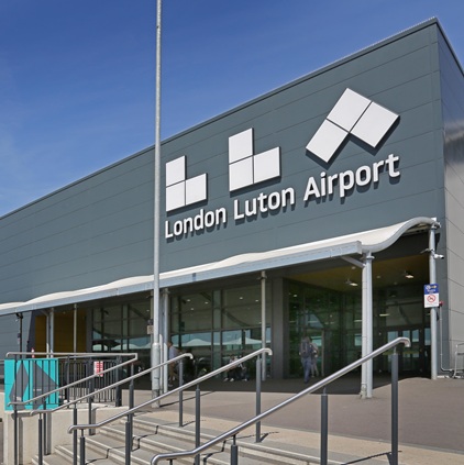 luton airport, london. passenger drop off area and entrance to the main terminal building featuring new airport logo (summer 2019)